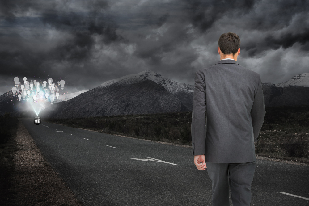 man-walking-along-dark-road